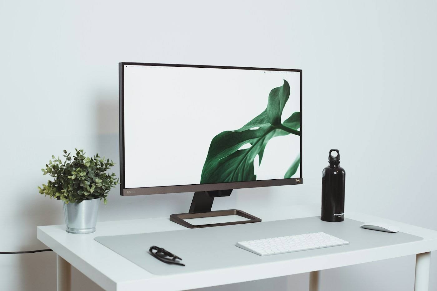 A monitor on a clear white desk