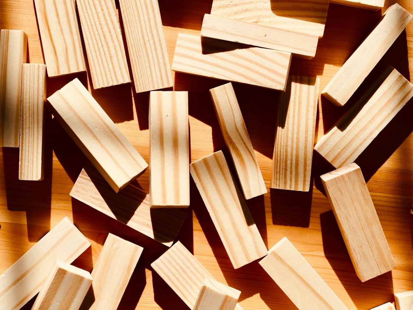 Wooden building blocks scattered on a table