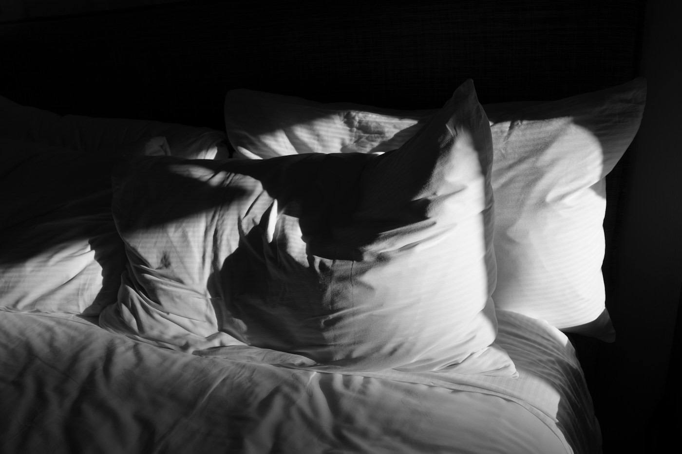 White pillows on a bed in morning light
