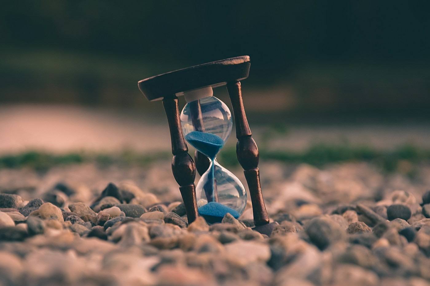 An hourglass on stones